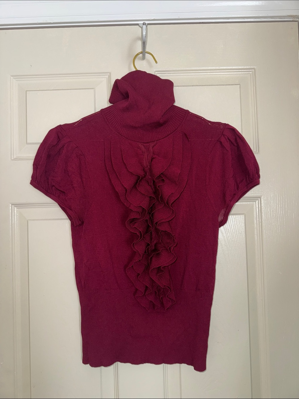 Short SleeveTurtleneck Sweater In A Deep Berry/Maroon Front Ruffle Bib Detail